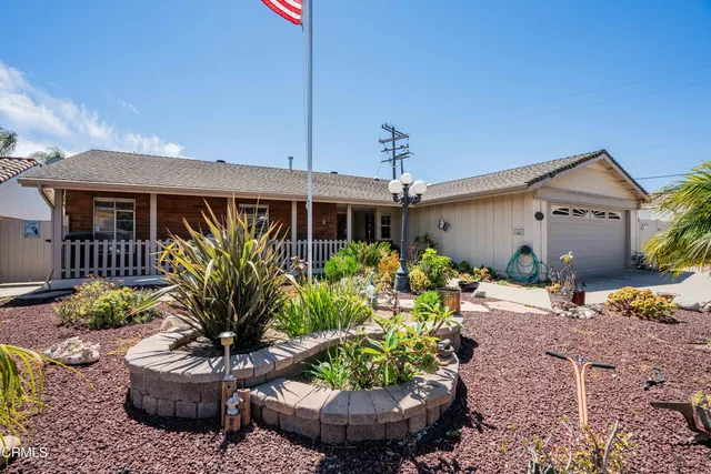 a couple of potted plants in front of a house