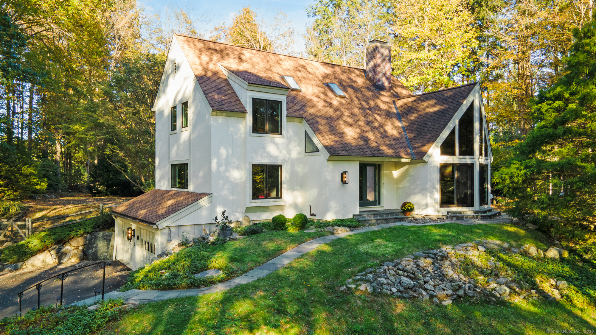 a front view of house with yard and trees in the background