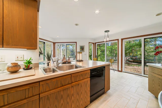 a kitchen with sink and view of living room