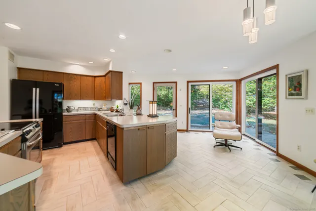 a kitchen with a sink a counter top space appliances and cabinets