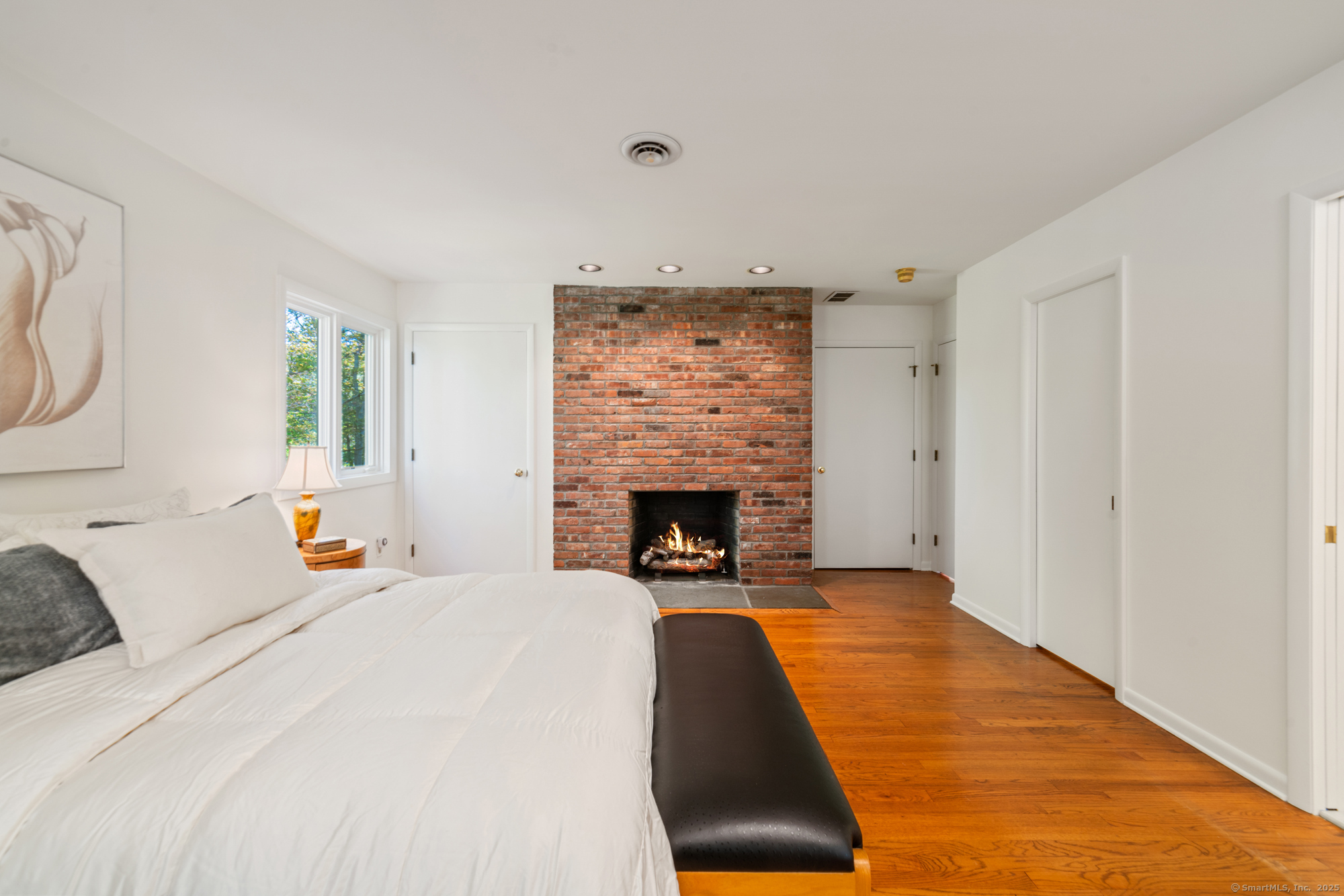 34 Echo Valley Road Newtown, CT 06470 - Photo 23 of 40 a bed room with a bed and a fireplace