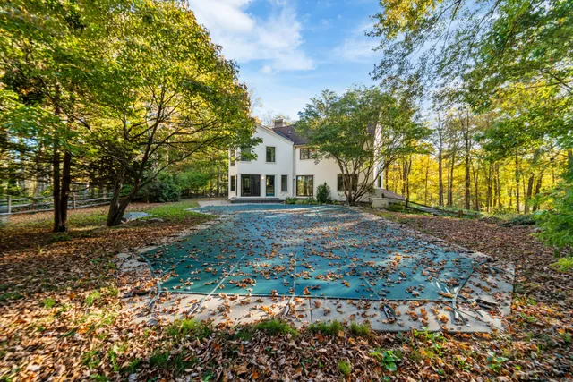 a view of house with backyard