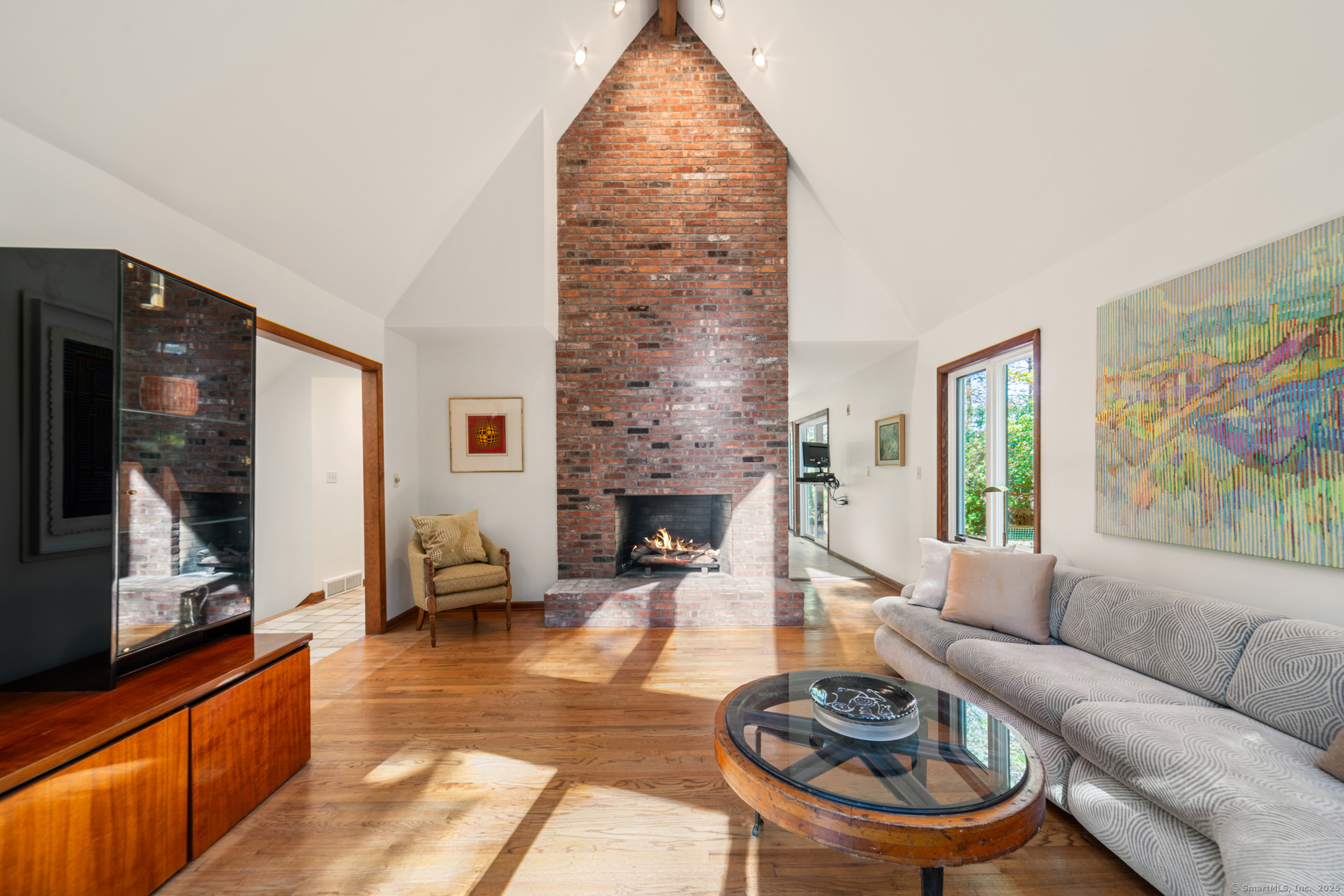 34 Echo Valley Road Newtown, CT 06470 - Photo 6 of 40 a living room with furniture a fireplace and a flat screen tv