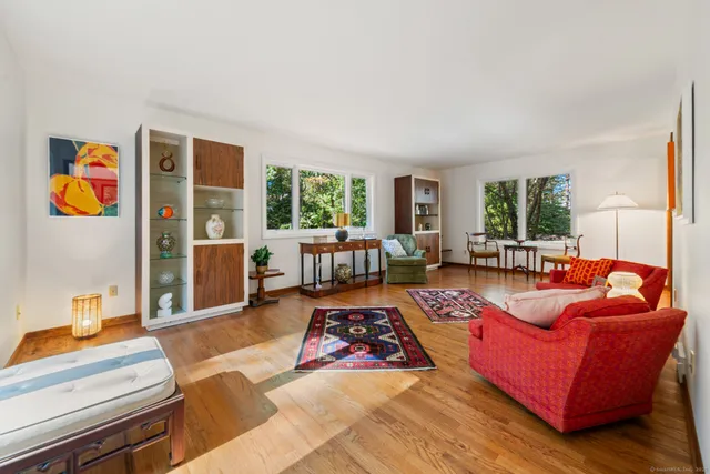 a living room with furniture fireplace and window
