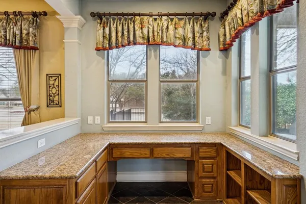 a view of a kitchen with a window and brick walls
