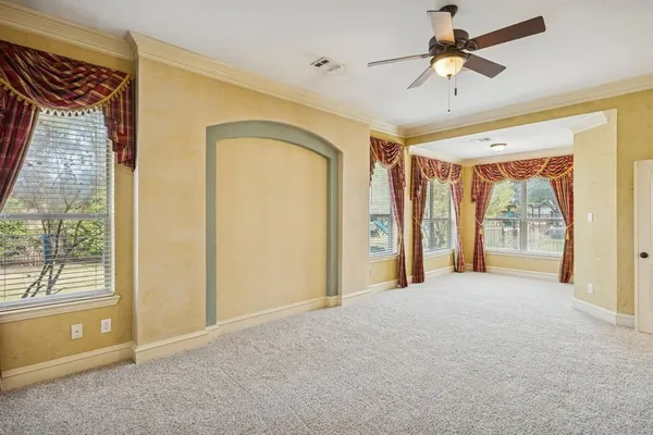 a view of a livingroom with a ceiling fan and window