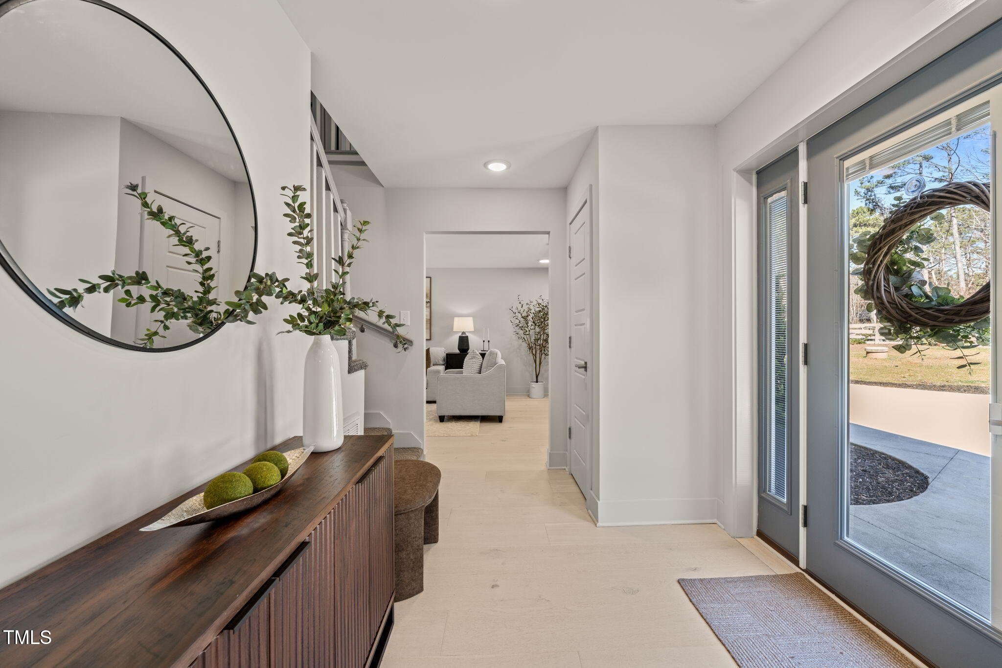 11801 Old Creedmoor Road Raleigh, NC 27613 - Photo 14 of 52 a hallway with painting and wooden floor
