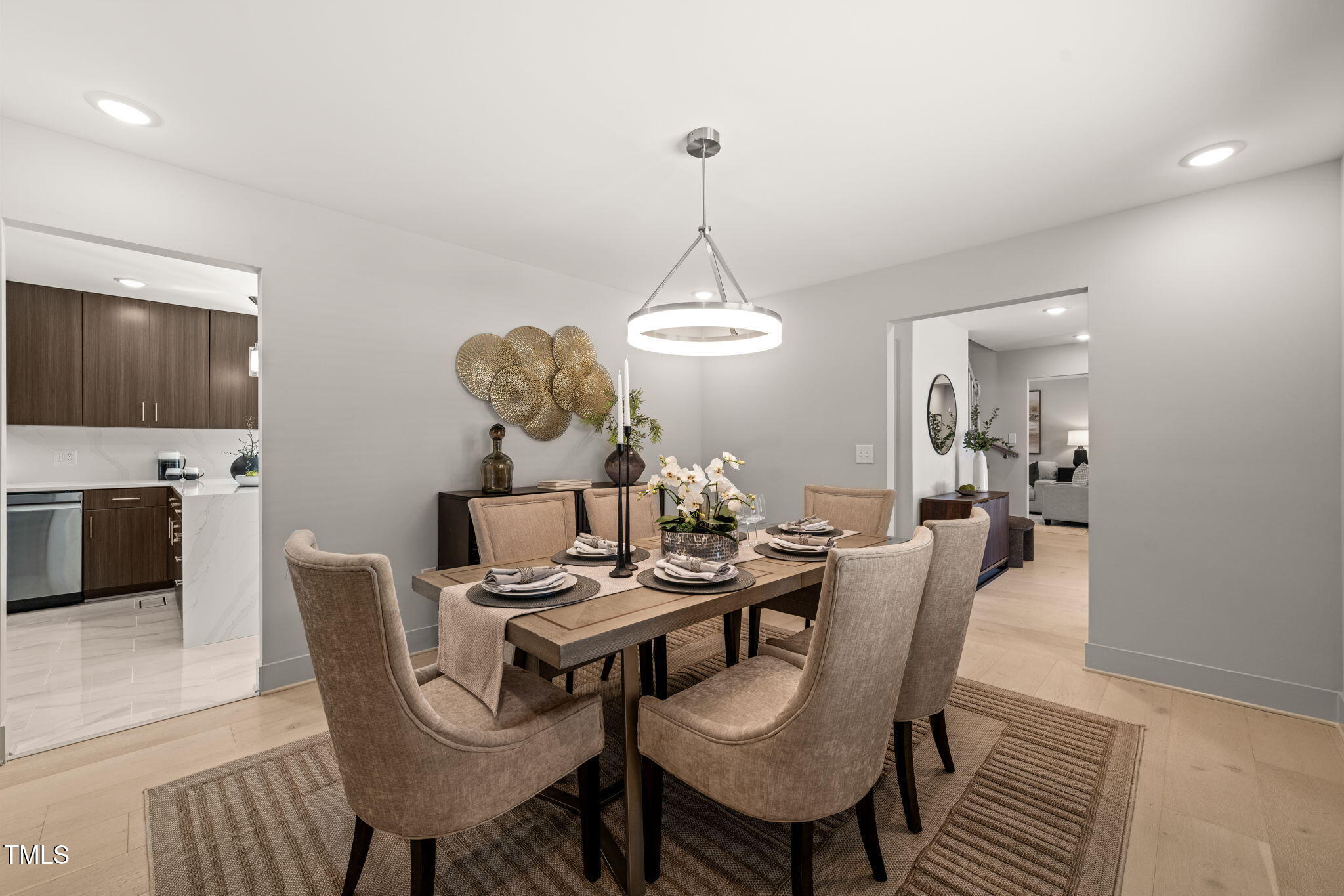 11801 Old Creedmoor Road Raleigh, NC 27613 - Photo 19 of 52 a dining room with furniture a chandelier and wooden floor