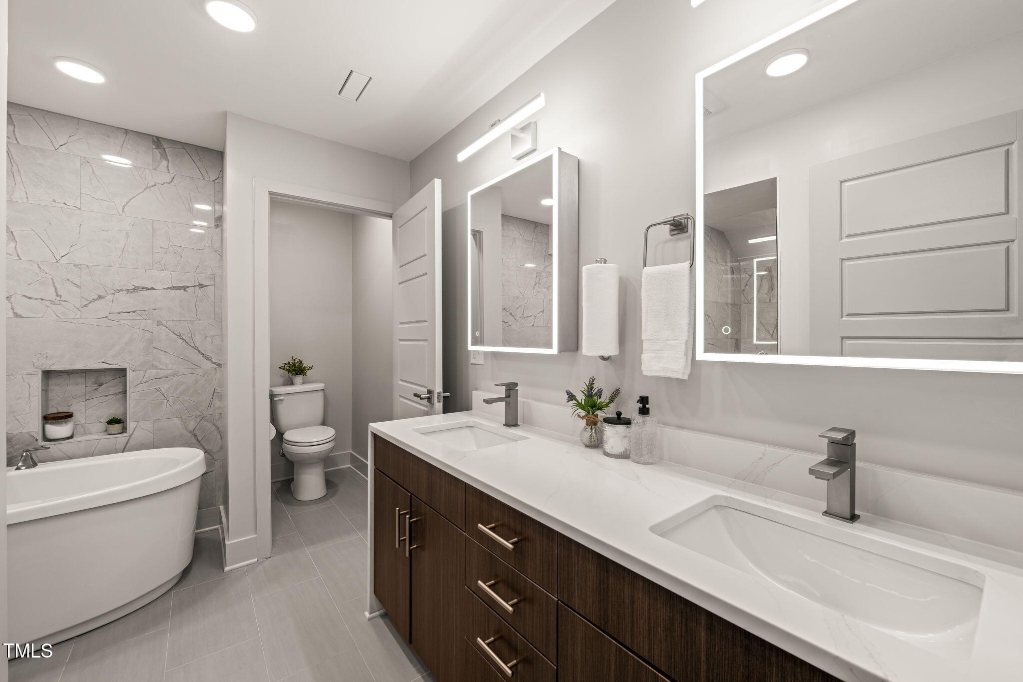 11801 Old Creedmoor Road Raleigh, NC 27613 - Photo 25 of 52 a bathroom with a double vanity sink and mirror with toilet