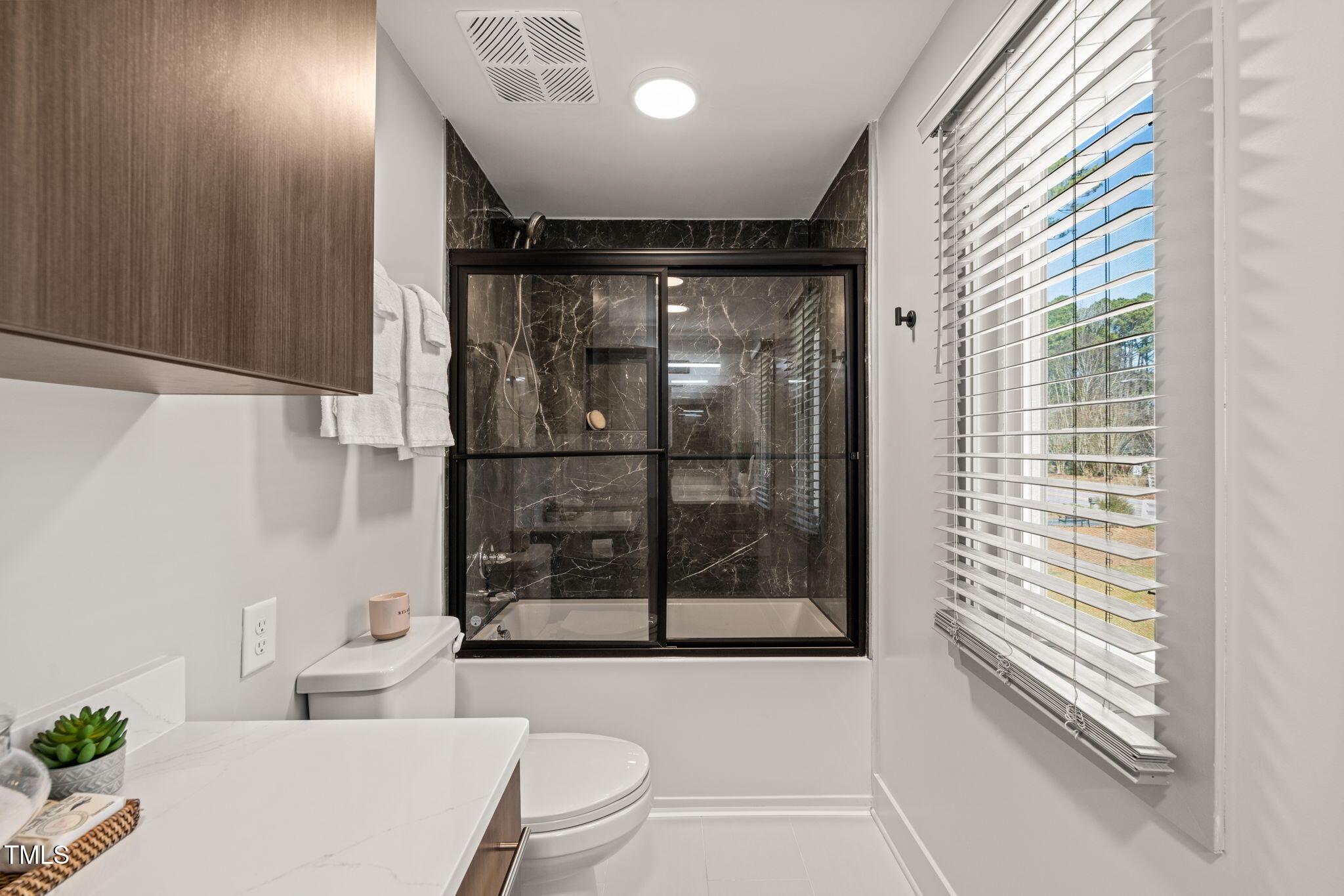 11801 Old Creedmoor Road Raleigh, NC 27613 - Photo 31 of 52 a bathroom with a toilet a sink and shower