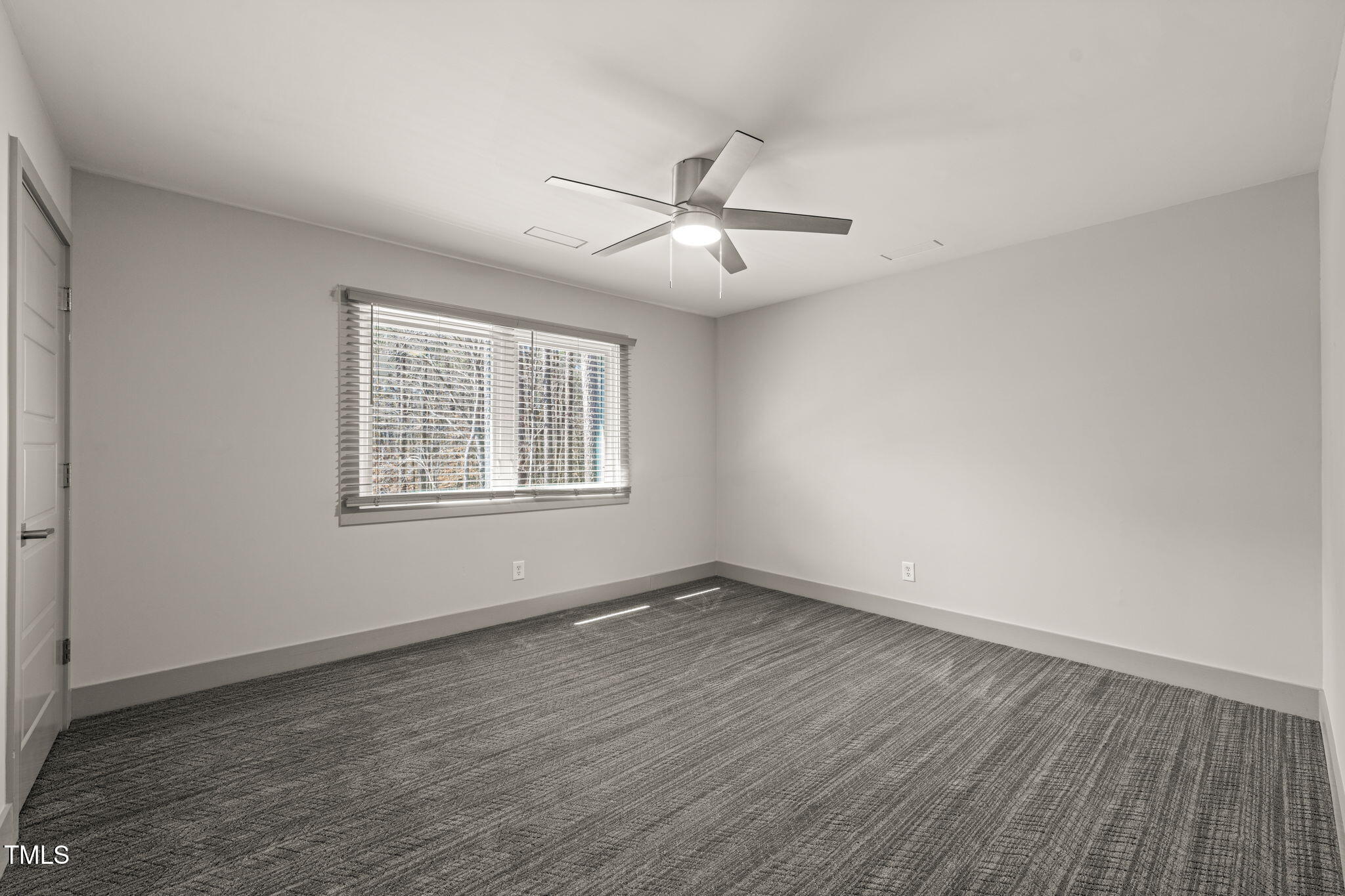 11801 Old Creedmoor Road Raleigh, NC 27613 - Photo 32 of 52 an empty room with wooden floor ceiling fan and windows