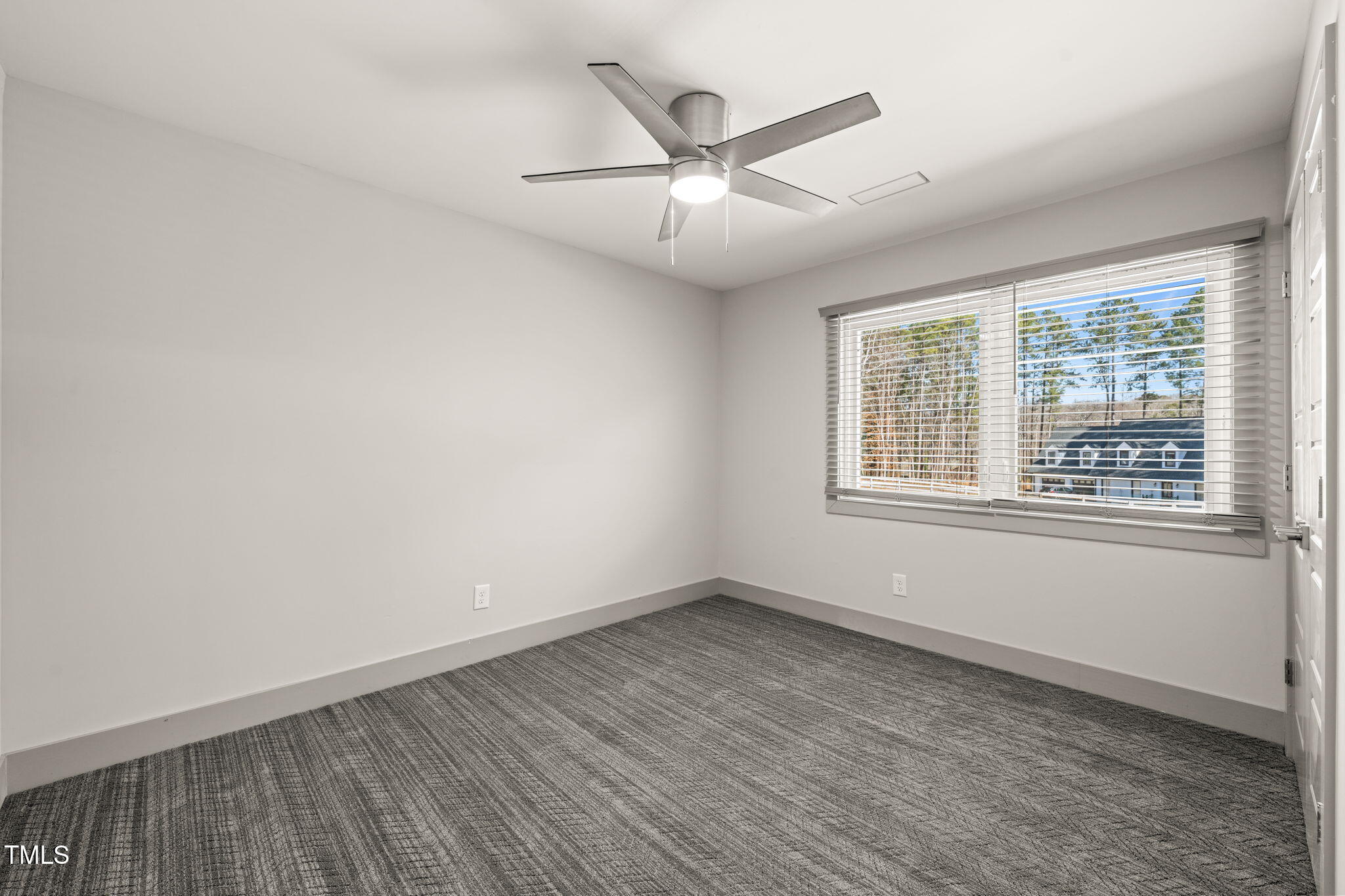 11801 Old Creedmoor Road Raleigh, NC 27613 - Photo 34 of 52 an empty room with wooden floor fan and windows