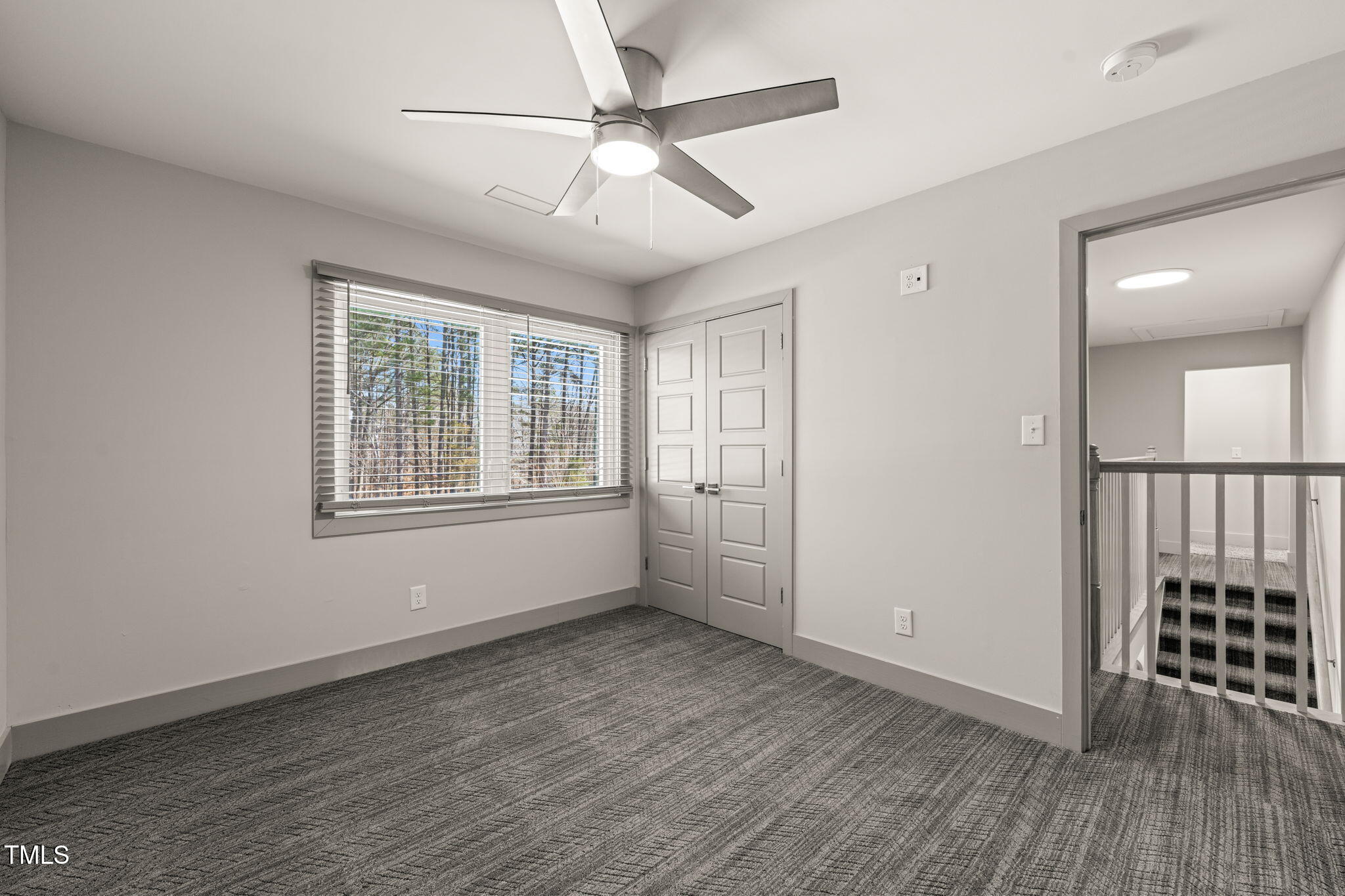11801 Old Creedmoor Road Raleigh, NC 27613 - Photo 35 of 52 an empty room with wooden floor fan and windows