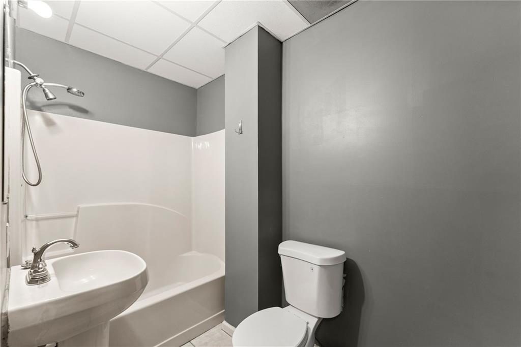 3523 Lighthouse Lane Gainesville, GA 30504 - Photo 48 of 72 a white toilet sitting next to a bathroom sink and tub
