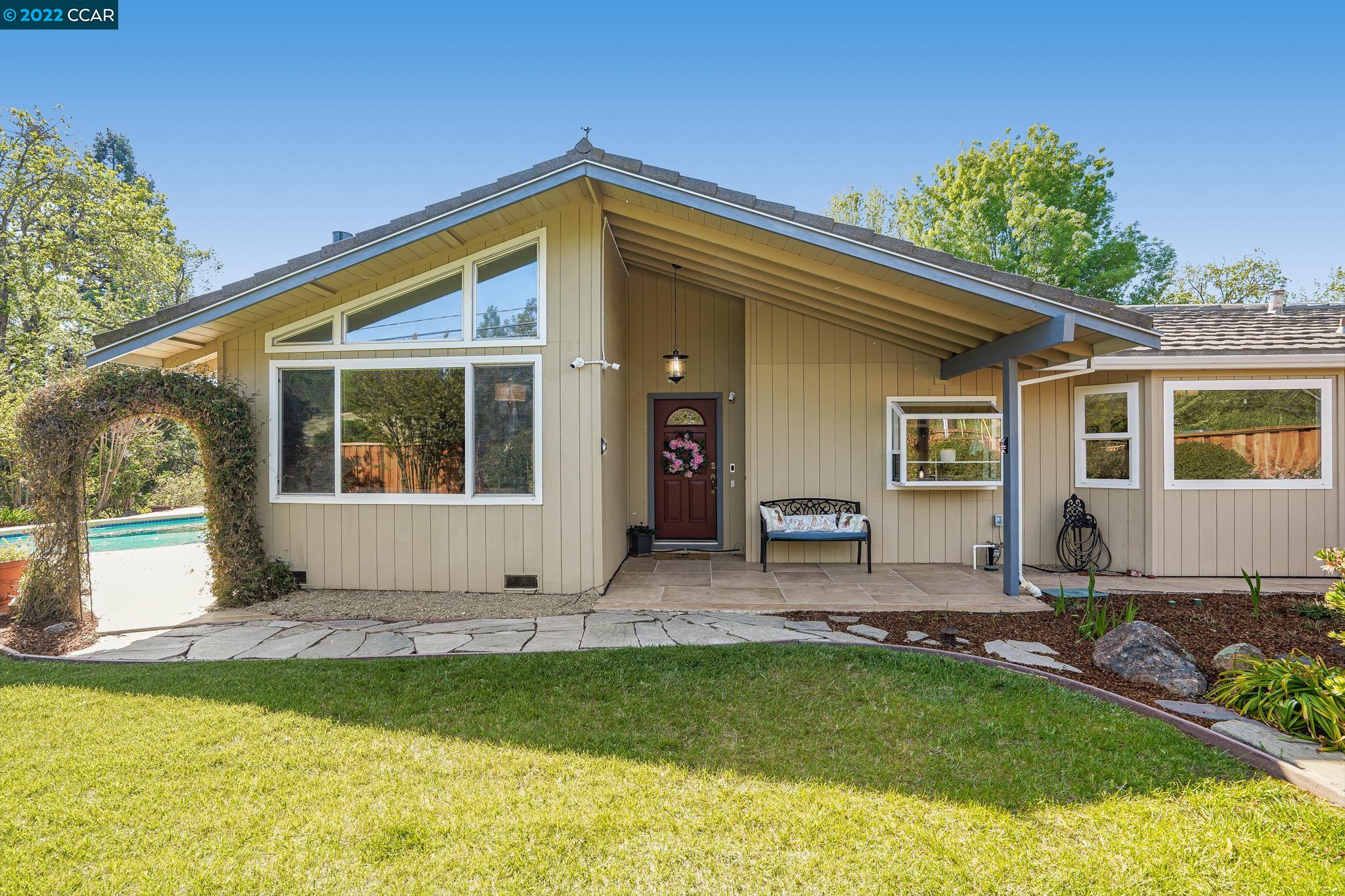 a front view of house with yard and outdoor seating