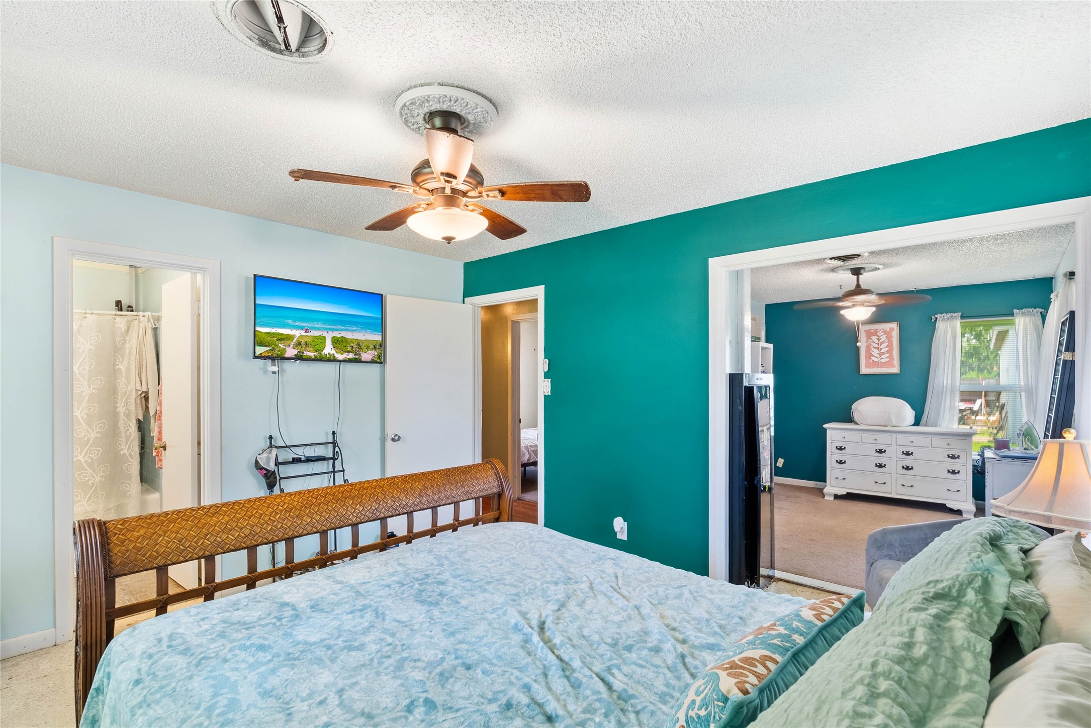 168 Sunset Ingleside, TX 78362 - Photo 14 of 26 Spacious secondary bedroom showcasing a vibrant accent wall and a ceiling fan.