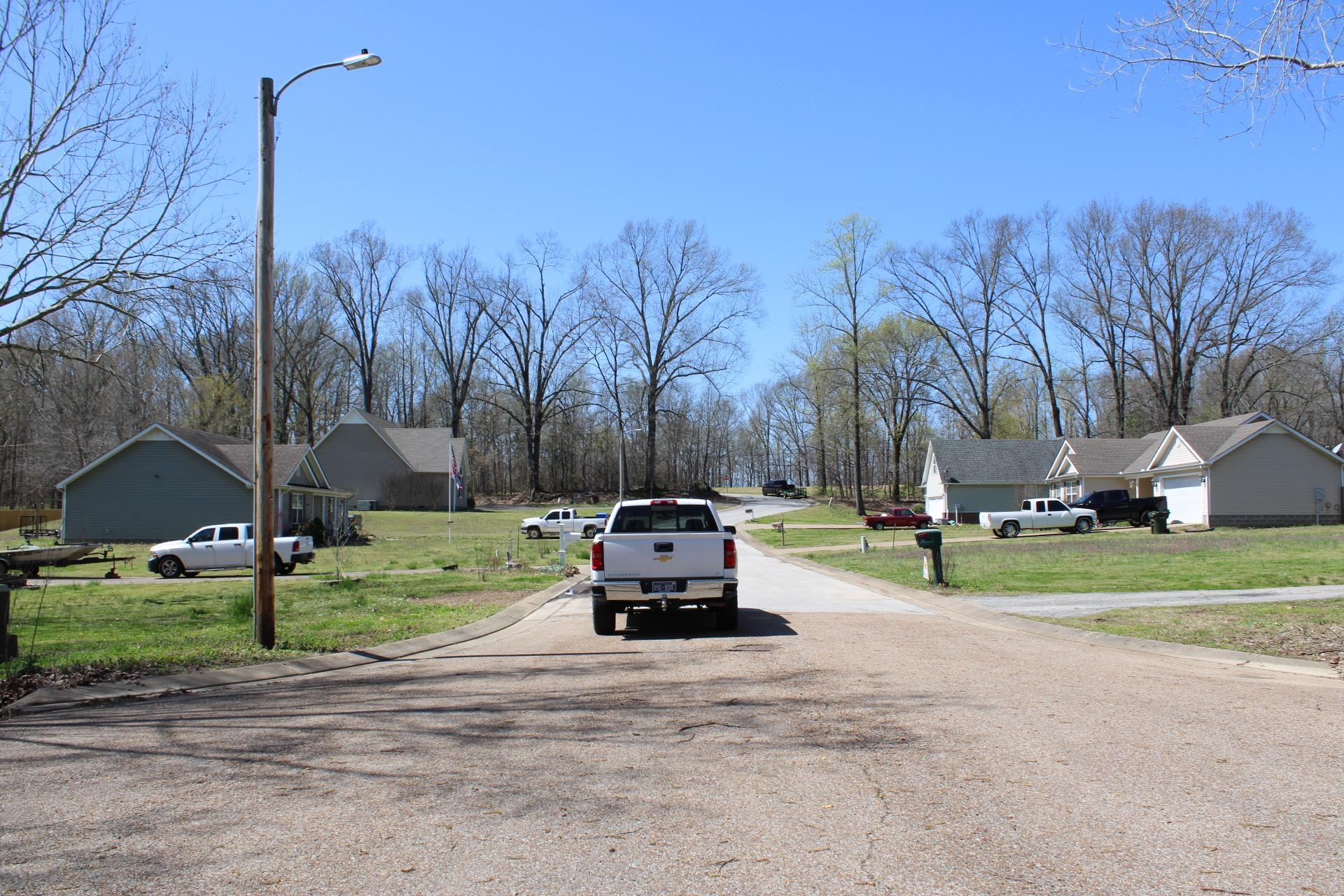 Lot 24 Walnut Ridge Ripley, TN 38063 - Photo 2 of 3 a car parked in front of a house and a yard
