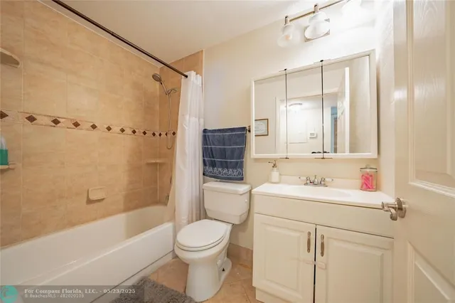 a bathroom with a sink toilet vanity and shower