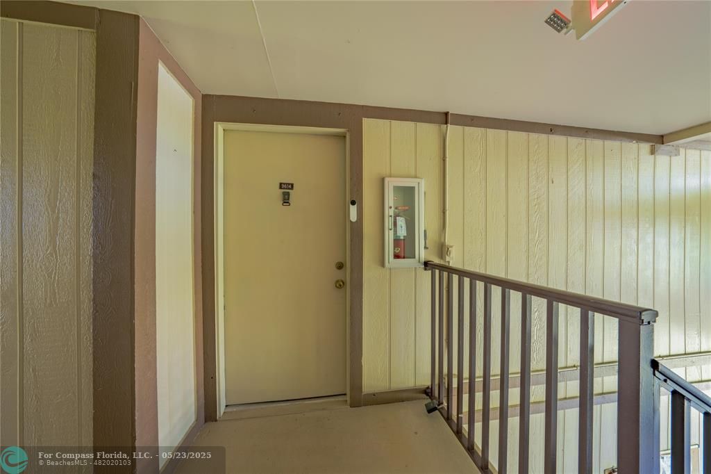 9614 West McNab Road, Unit 204 Tamarac, FL 33321 - Photo 20 of 37 a view of a hallway with a glass door