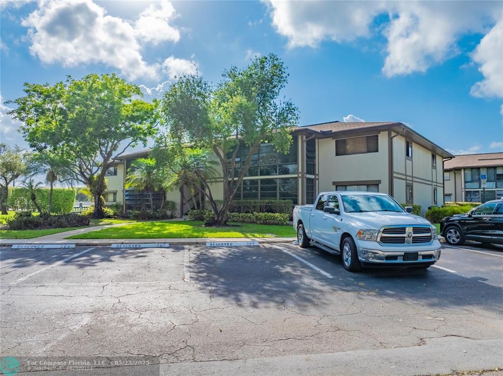 9614 West McNab Road, Unit 204 Tamarac, FL 33321 - Photo 21 of 37 a car parked in front of a house