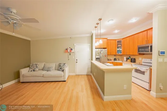 a living room with furniture and kitchen view