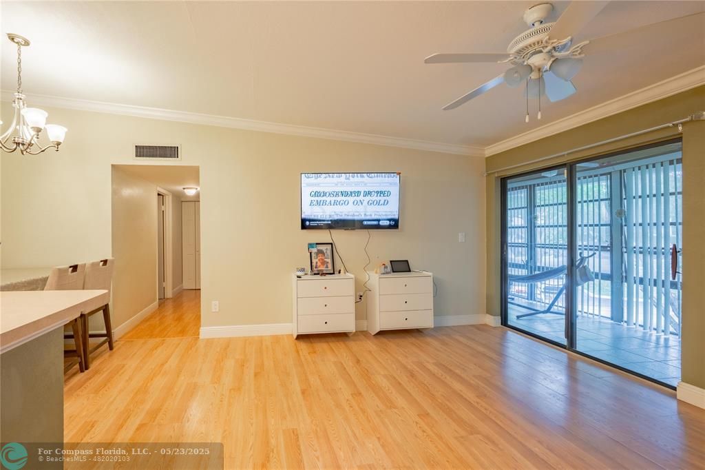 9614 West McNab Road, Unit 204 Tamarac, FL 33321 - Photo 4 of 37 a view of a livingroom with furniture and wooden floor