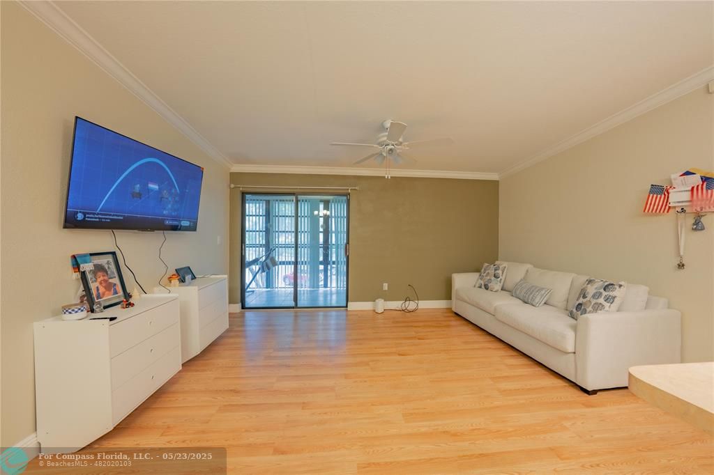 9614 West McNab Road, Unit 204 Tamarac, FL 33321 - Photo 7 of 37 a living room with furniture and wooden floor