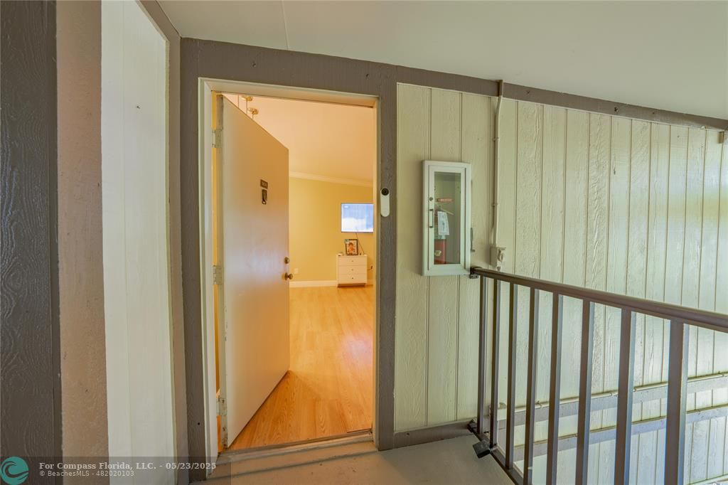 9614 West McNab Road, Unit 204 Tamarac, FL 33321 - Photo 8 of 37 a view of a hallway with wooden floor and a door