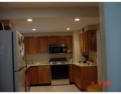 29 Griffin Road Framingham, MA 01701 - Photo 3 of 14 a kitchen with stainless steel appliances kitchen island granite countertop a refrigerator and a stove top oven