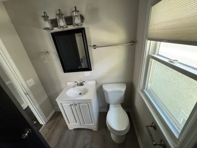 a bathroom with a toilet sink and mirror