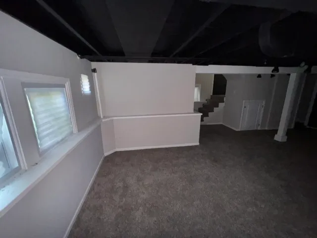 a view of an empty room with a kitchen