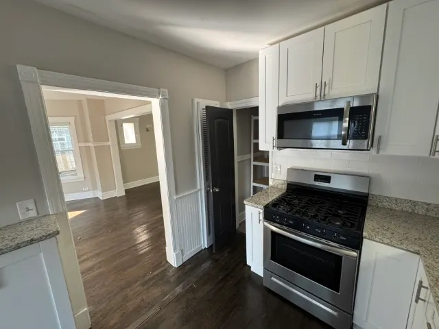 a kitchen with granite countertop cabinets and steel stainless steel appliances