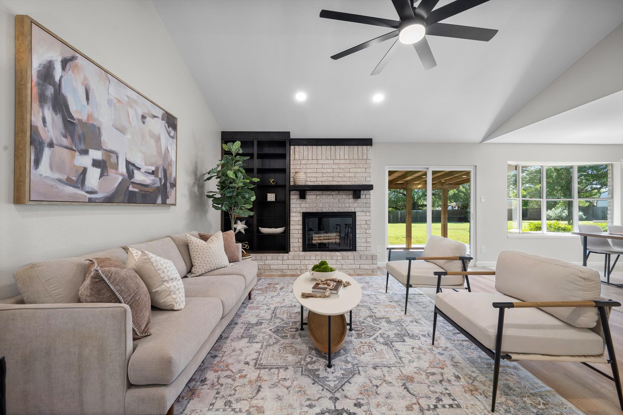 109 Woodland Road Georgetown, TX 78628 - Photo 20 of 40 Vaulted ceilings and a classic fireplace create an inviting atmosphere in this sun-filled living space.