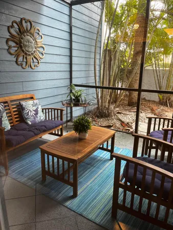 a view of a chairs and table in the balcony