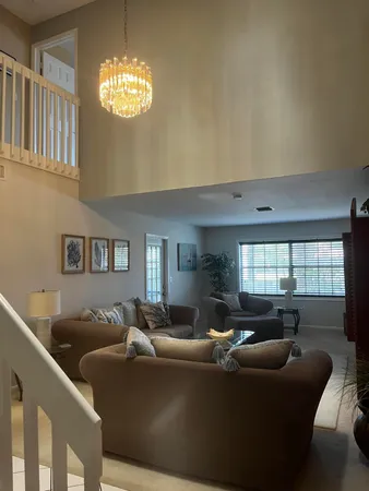 a living room with furniture and a chandelier