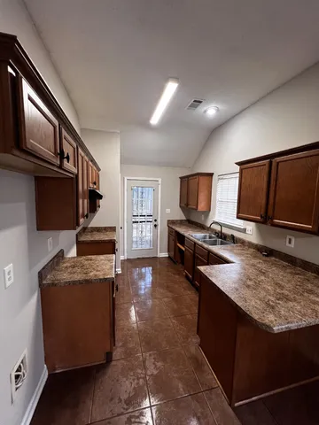 a kitchen with stainless steel appliances granite countertop a stove refrigerator and a microwave
