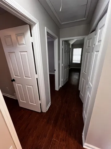 a view of a hallway and wooden floor