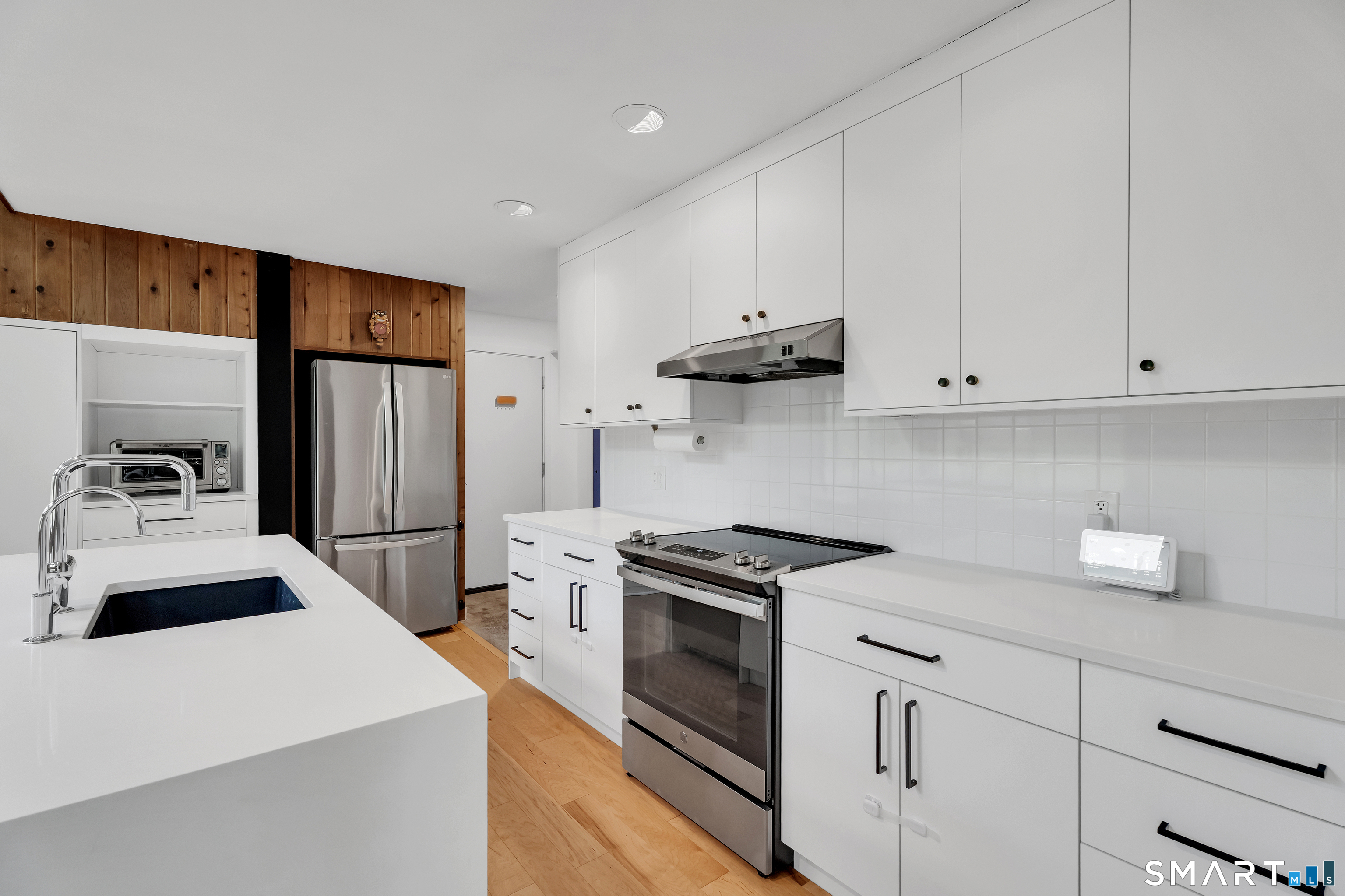 841 Prospect Street Hamden, CT 06517 - Photo 15 of 40 a kitchen with white cabinets and stainless steel appliances