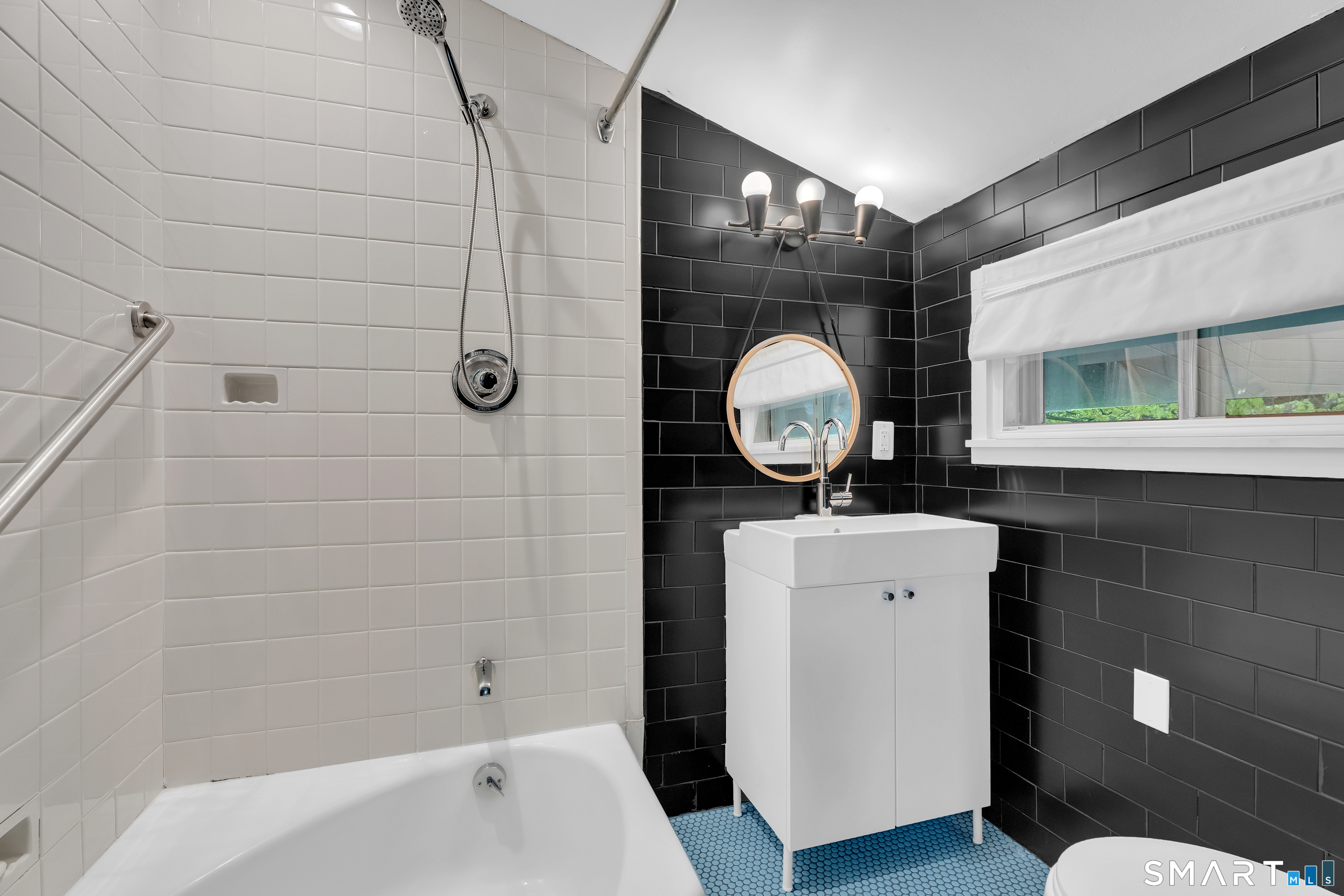 841 Prospect Street Hamden, CT 06517 - Photo 31 of 40 a bathroom with a toilet a sink and mirror