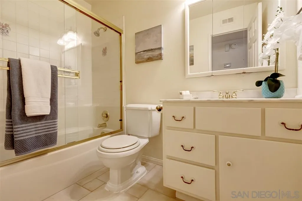 13856 Olive Grove Place Poway, CA 92064 - Photo 12 of 25 a bathroom with a sink a toilet and shower