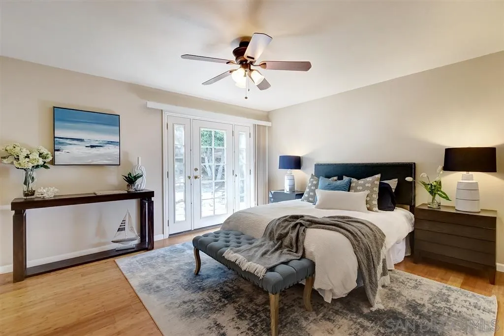 13856 Olive Grove Place Poway, CA 92064 - Photo 16 of 25 a bedroom with a bed and a chandelier