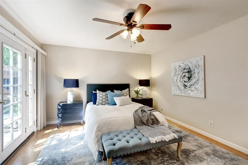 13856 Olive Grove Place Poway, CA 92064 - Photo 18 of 25 a bedroom with a bed and wooden floor