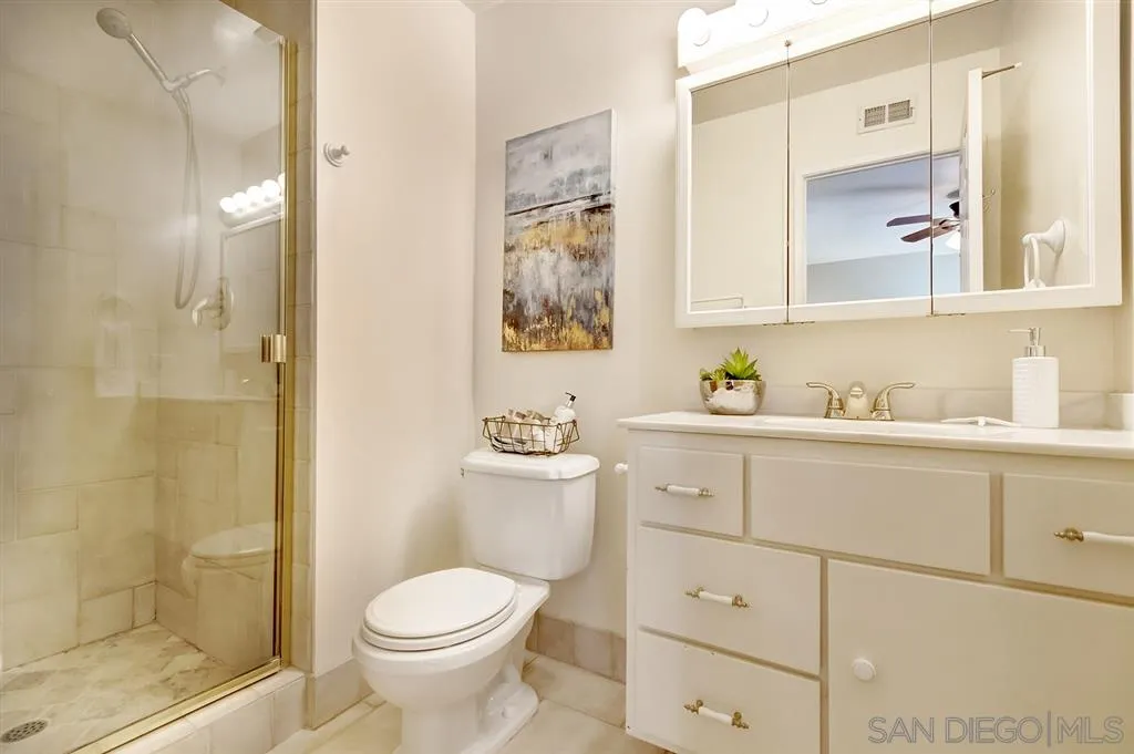 13856 Olive Grove Place Poway, CA 92064 - Photo 20 of 25 a bathroom with a toilet sink and shower