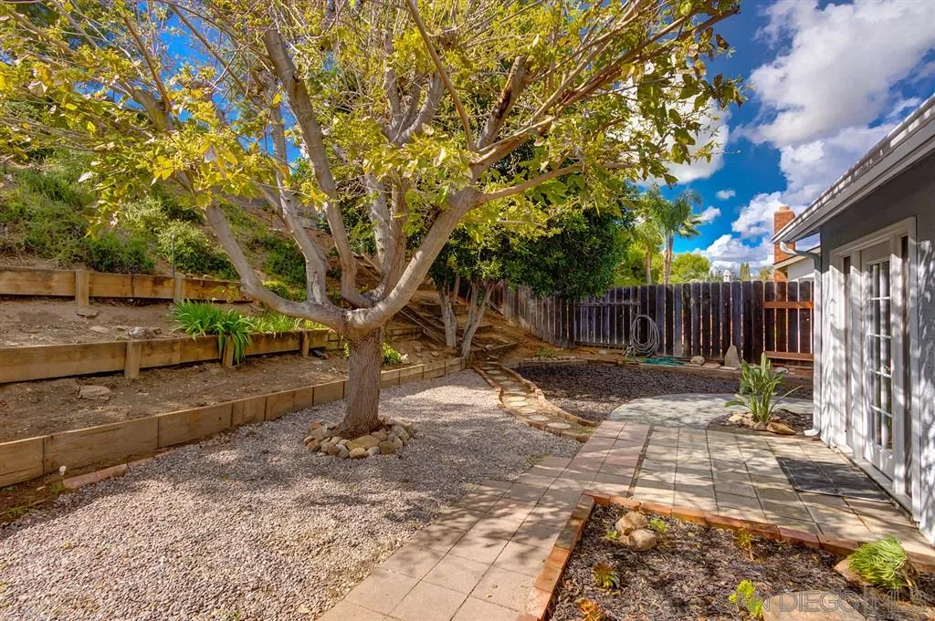 13856 Olive Grove Place Poway, CA 92064 - Photo 23 of 25 a view of a yard with wooden fence and a bench