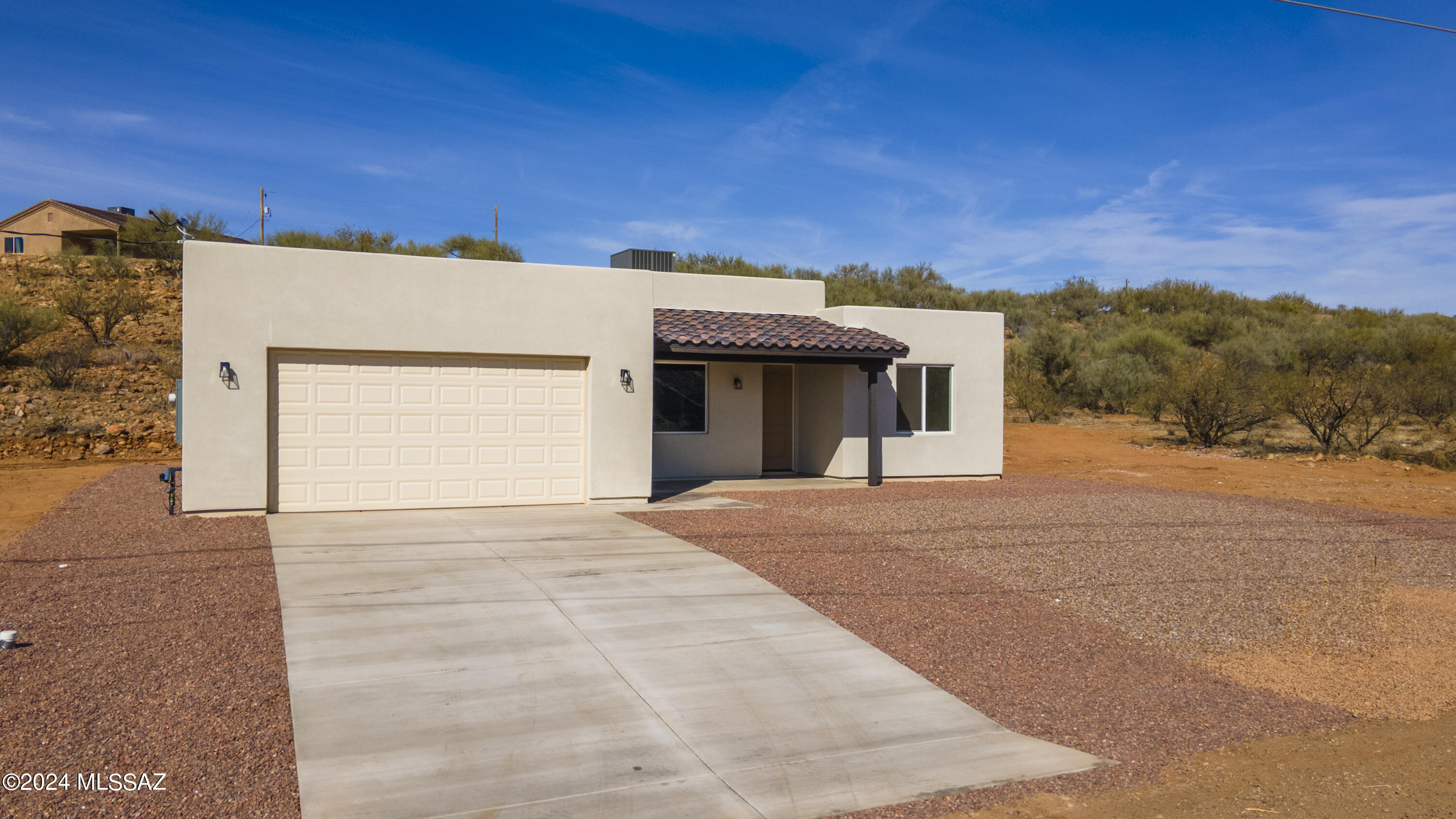 1817 Vereda Iberia Rio Rico, AZ 85648 - Photo 4 of 25 a front view of a house with a yard and garage