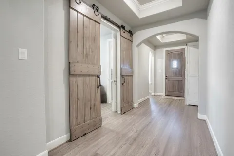 a kitchen with kitchen island granite countertop a stove a sink and a wooden floor