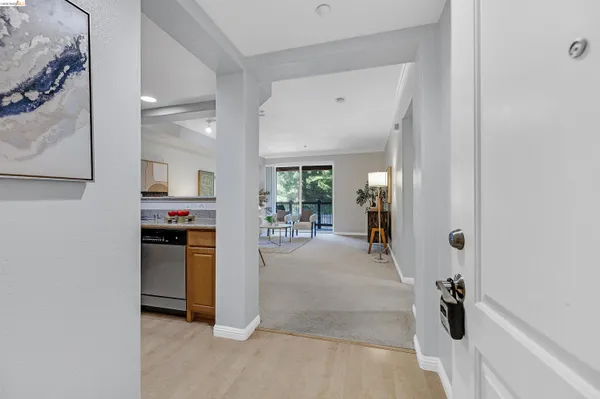 a view of a hallway to kitchen and dining room