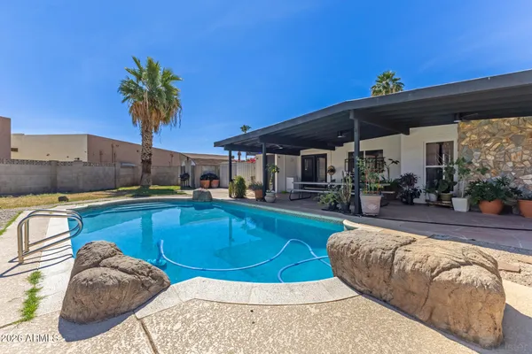 a view of a swimming pool with a patio