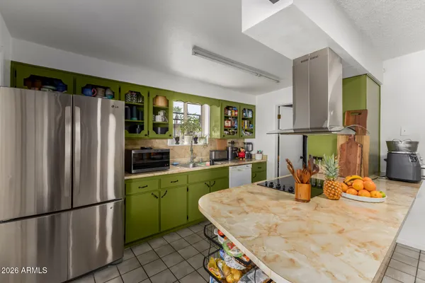 a kitchen with refrigerator and window