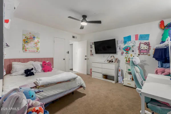 a bedroom with furniture and a flat screen tv